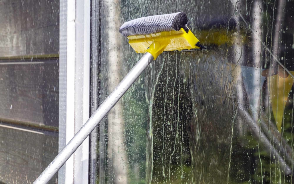 Close up view of a squeegee cleaning a window