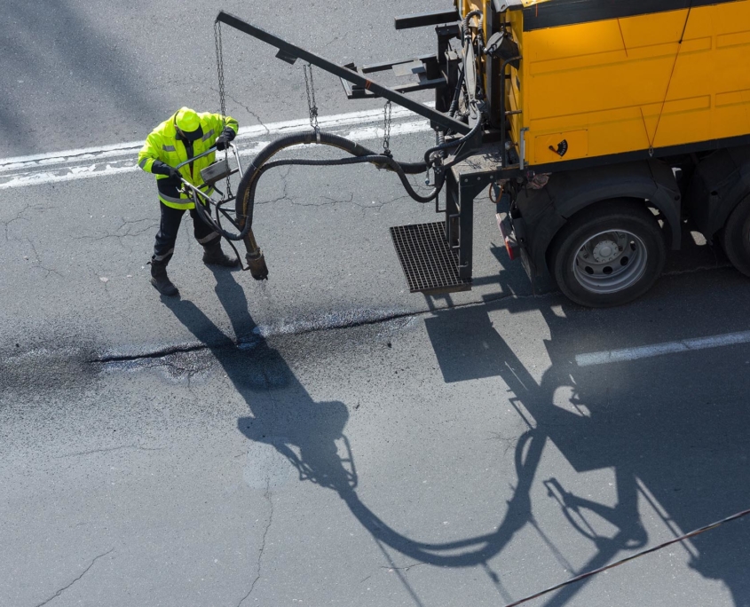 Asphalt sealing truck spraying on roadway