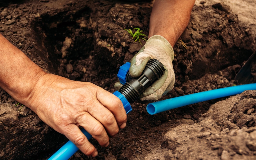 Close up view of a person working on irrigation system