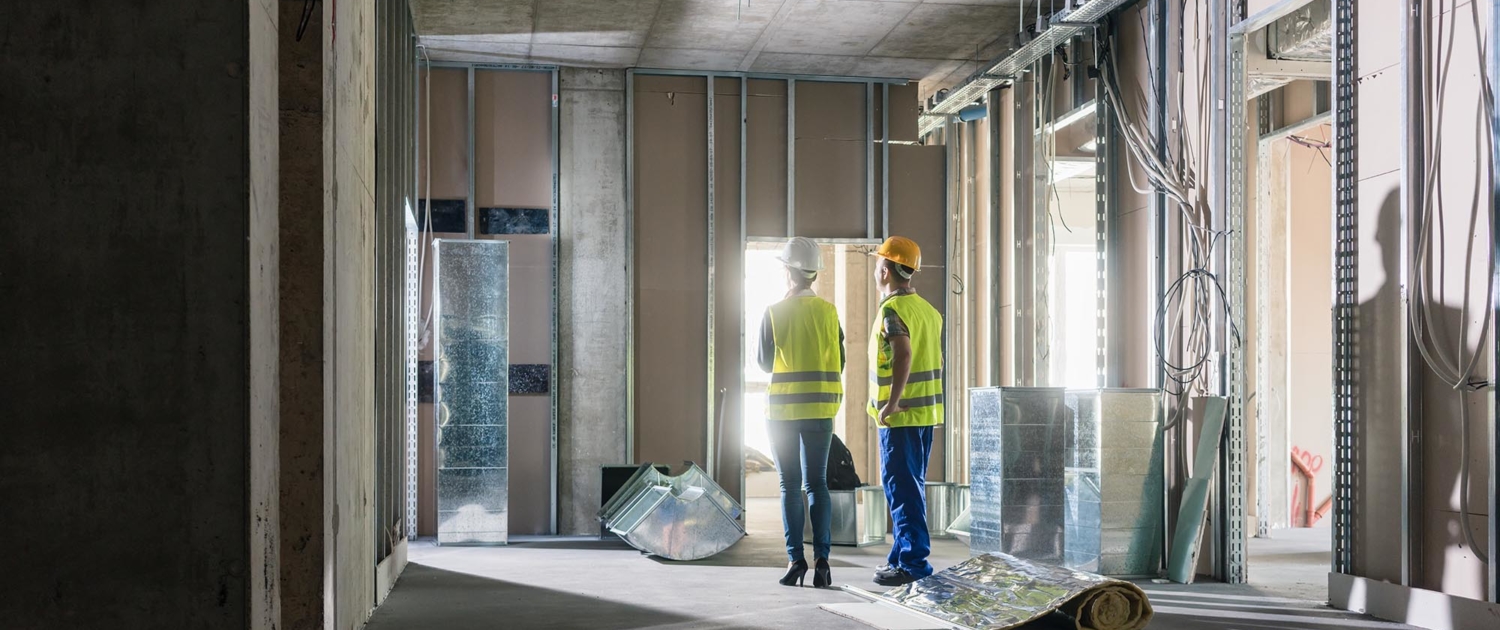 Side view of two people inside a in progress building