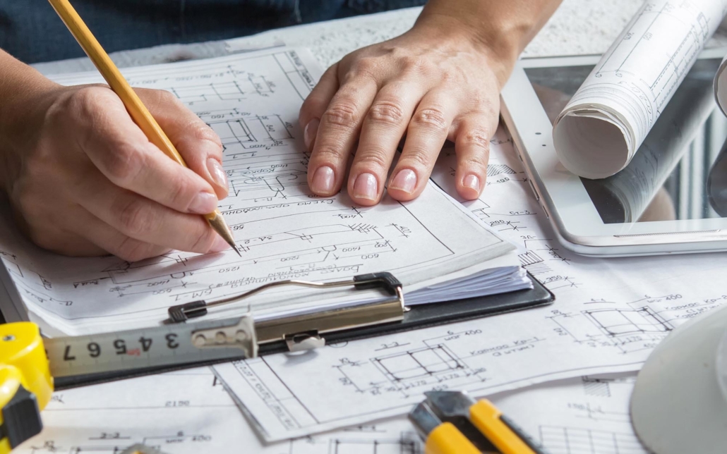 View of a person working on blue prints