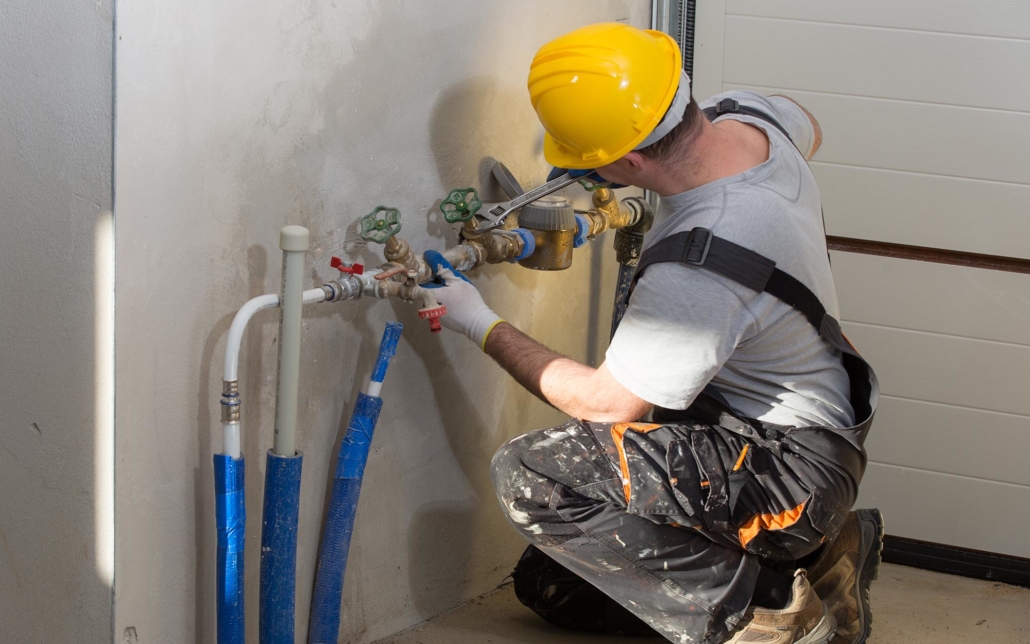 View of a plumber installing pipe work