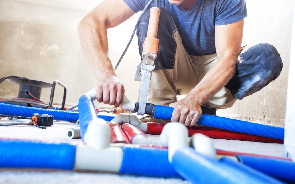 View of a plumber working on piping