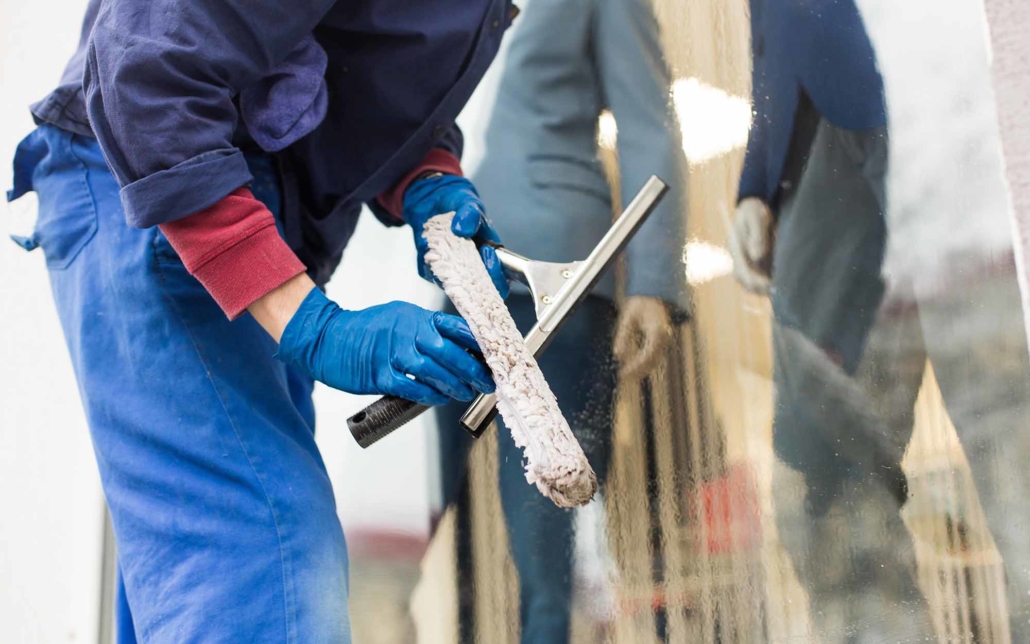 Worker prepping a squeegee for cleaning