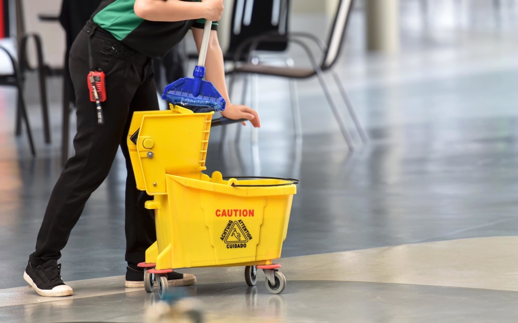 Person using a mop cart to clean floors