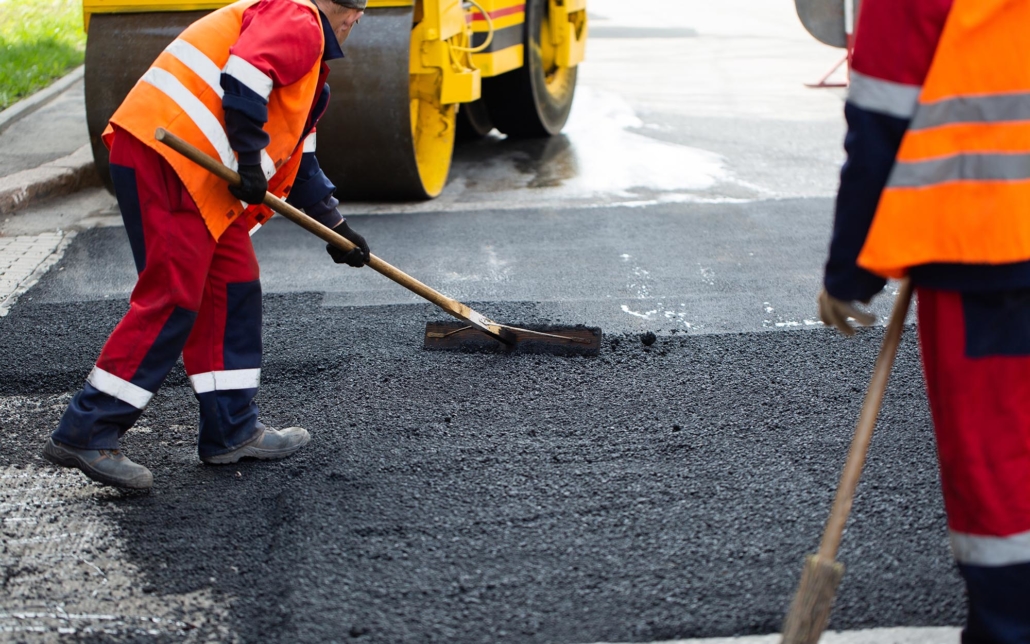 View of a road crew working in new asphalt