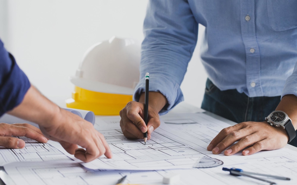 View of two contractor workers looking over plans